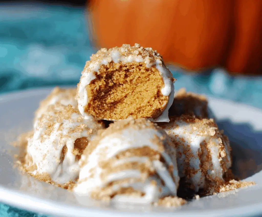 Creamy no-bake pumpkin cheesecake balls topped with crushed cookies, perfect for fall dessert or holiday treats.