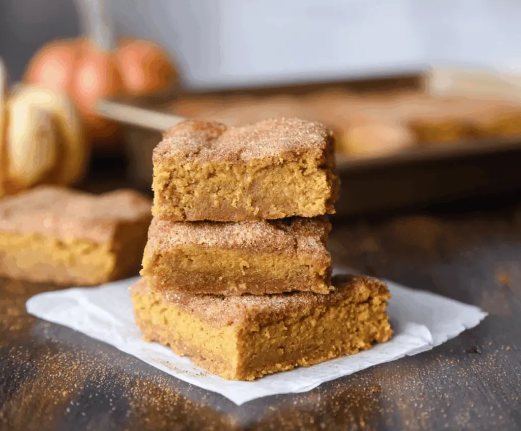 Delicious Pumpkin Snickerdoodle Bars topped with cinnamon sugar, perfect for fall baking and dessert cravings.