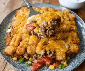 Delicious Cowboy Casserole with ground beef, vegetables, and cheese served in a baking dish