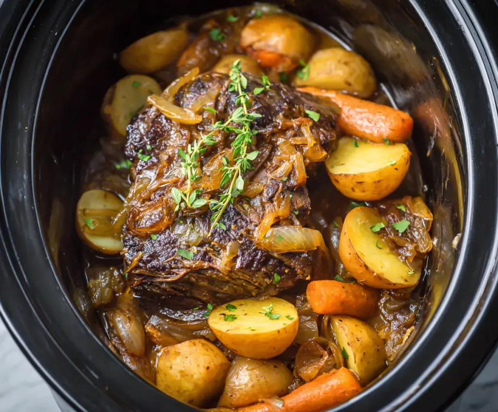 Delicious Crockpot French Onion Pot Roast served with caramelized onions and tender beef.