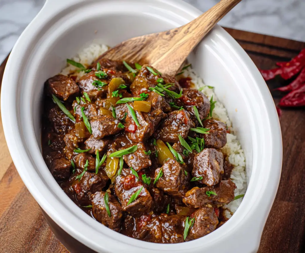 Delicious Crockpot Mississippi Steak Bites served with fresh herbs and crispy vegetables.