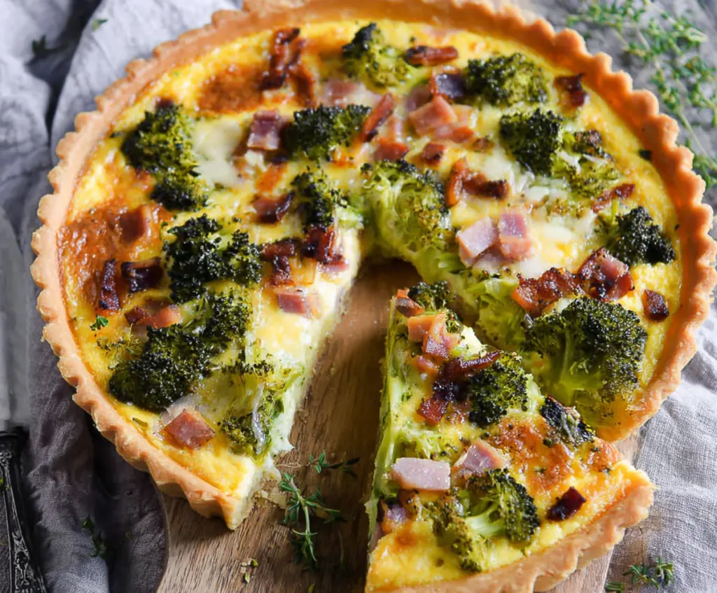 Delicious savory ham and broccoli tart served fresh on a rustic plate