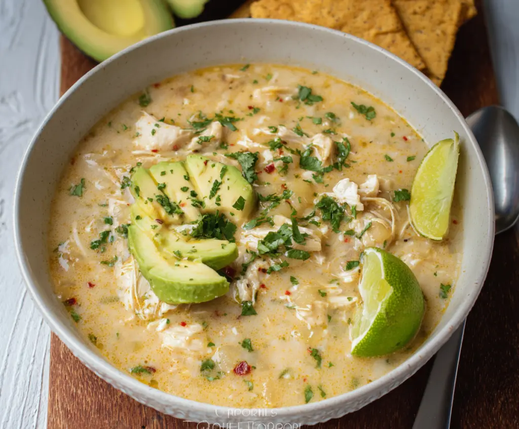 Delicious Whole30 White Chicken Chili in a bowl with fresh herbs and spices