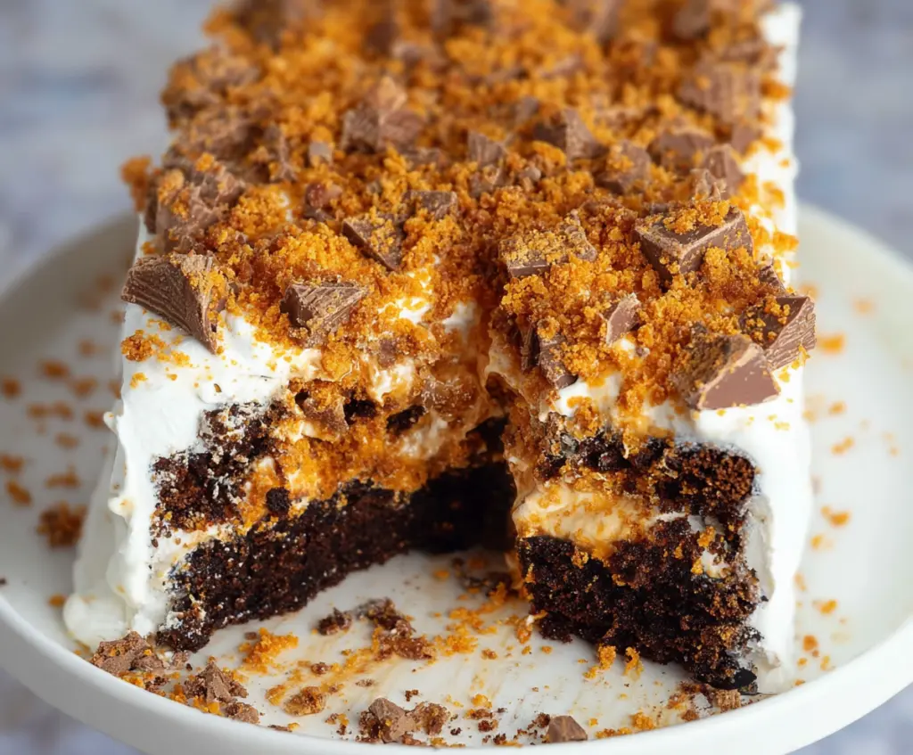 Delicious Butterfinger Cake with layers of creamy frosting and crunchy Butterfinger chunks